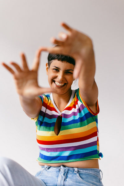 Smiling lesbian woman blocking the camera in a studio