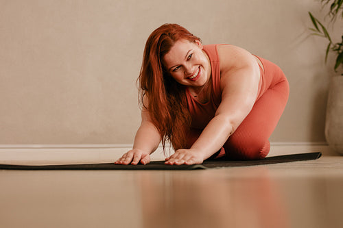 Female practicing yoga at home