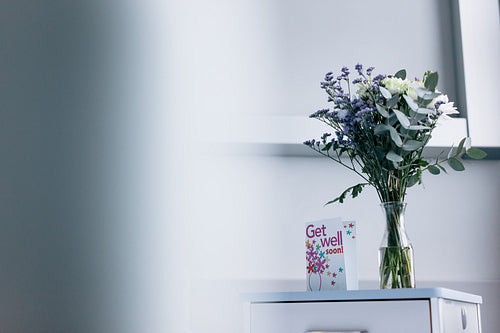 Get well soon card with flowers in hospital ward