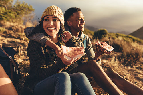Friends on hiking trip having pizza