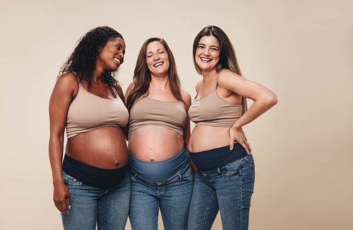 Pregnant women celebrating the third trimester with smiles and support