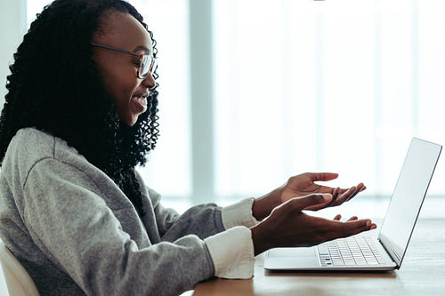Female interior designer conducting an online consultation with a client using a laptop