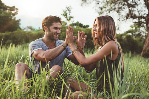 Happy young couple enjoying a day in meadow