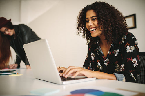 Cheerful businesswoman at work in office