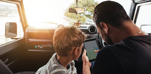 Father and son looking for route on map