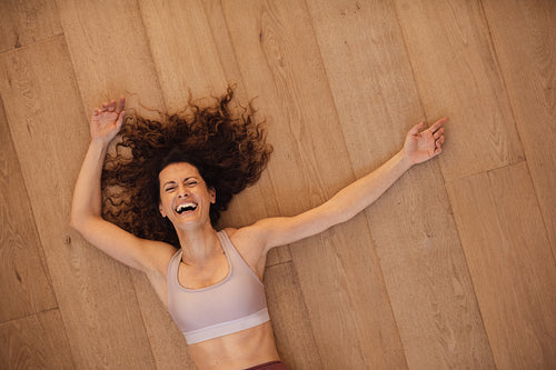 Smiling woman relaxing after workout at home