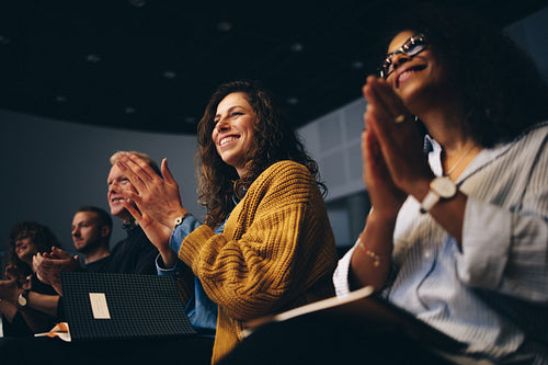 Business people clapping hands during a the forum