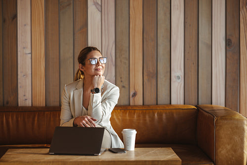 Thoughtful business woman sitting in a coffee shop