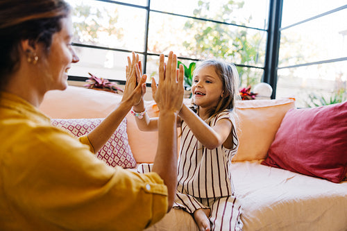 Family high five moment at home