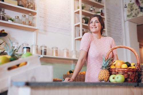 Young woman working at a juice bar