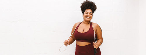 Body positive woman with jumping rope