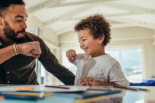 Father and son giving a fist bump