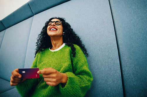 Her student budget starts with a credit card and a smile indoors