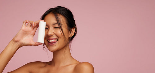 Asian female model showing a skin product