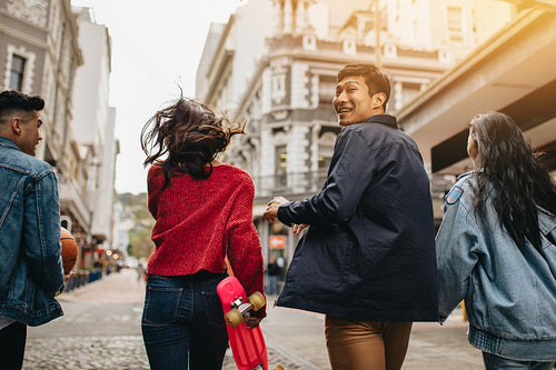 Asian man walking with friends