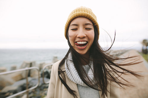 Smiling woman standing outdoors having fun