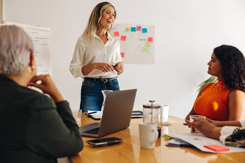 Happy businesswoman having a meeting with her team