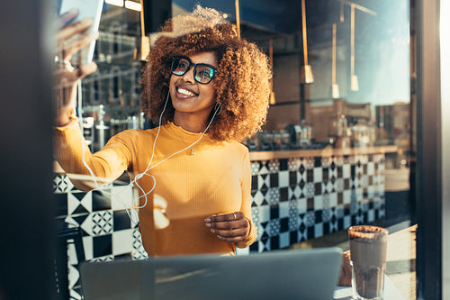 Freelancer woman taking a selfie sitting in a cafe