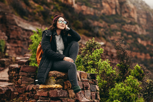 Female traveler relaxing at the hillside admiring the view
