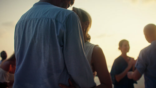 Happy couple enjoying a romantic sunset dance at a beautiful island resort