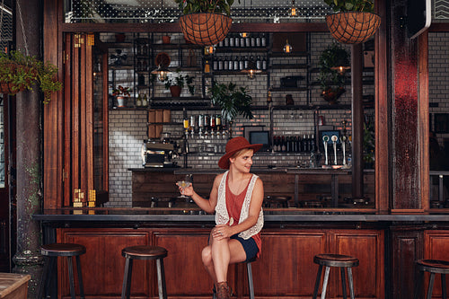 Attractive young woman sitting alone at a cafe
