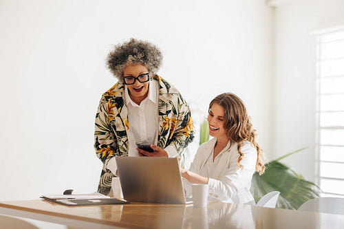 Happy businesswomen having a video call in a modern office