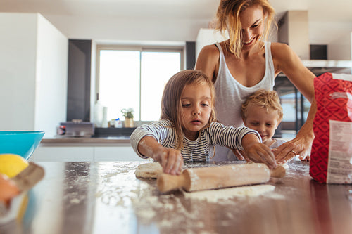 Family making cookies in kitchen
