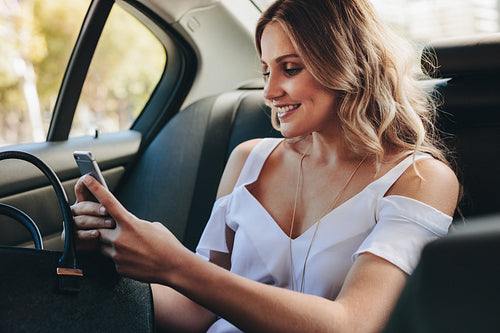 Real estate agent texting client during commute