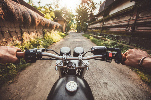 Biker driving his motorcycle on country road