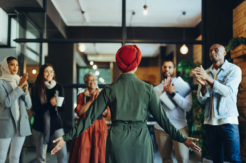 Businesswoman receiving an applause during a meeting