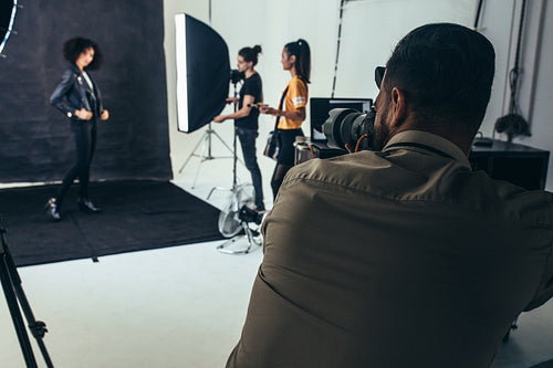 Studio shot of a photographer doing a photo shoot