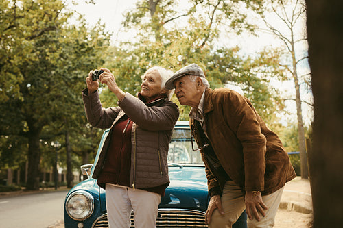 Senior couple on road trip taking pictures