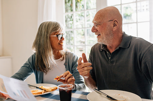 Senior couple having breakfast together at home