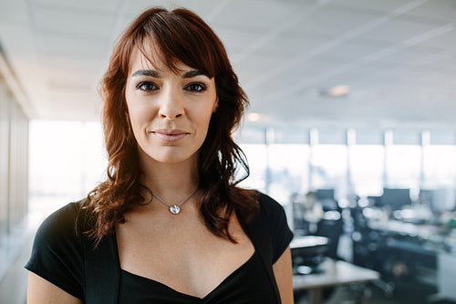 Confident mature businesswoman standing in office
