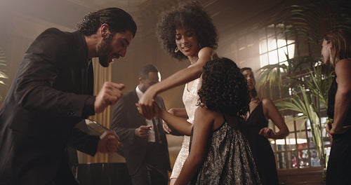 People dancing with a girl at party