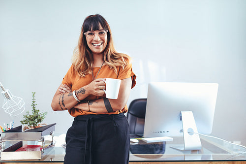 Creative woman entrepreneur standing in office