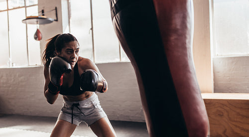 Female boxer training inside a boxing ring