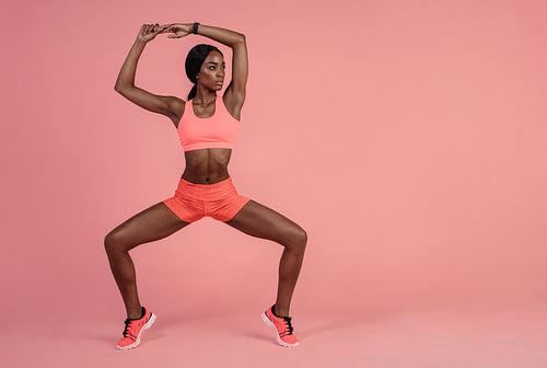 Fit woman doing stretching exercise