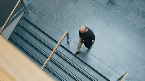 Business professionals in motion: Aerial view of working people moving around in a corporate environment
