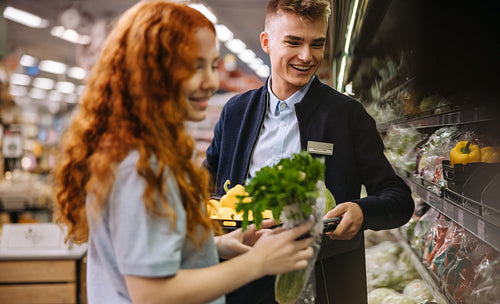 Employees packing fresh produce in supermarket