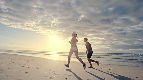 Couple jogging together on the beach