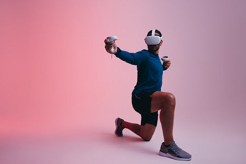 Young man playing archery in virtual reality