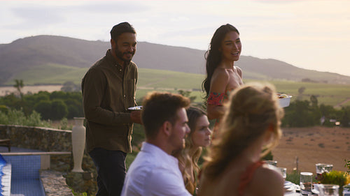 Couple serving food at party