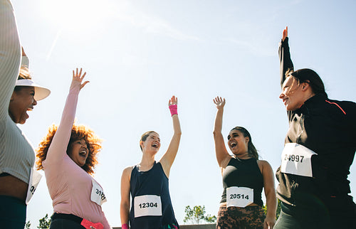 Diverse group celebrating teamwork at marathon event