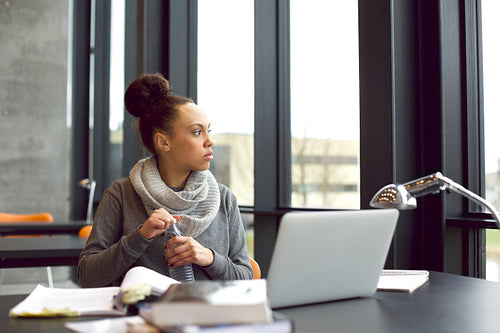 Woman taking a break while studying in library