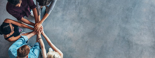 Stack of hands symbolizing trust and cooperation