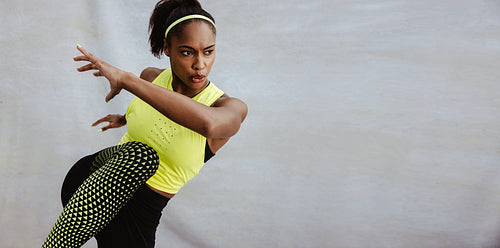 Young African woman doing stretching exercise