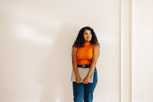 Happy young businesswoman looking away with a smile in an office