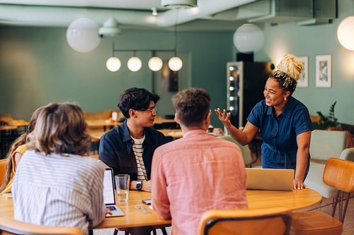 Diverse group discussing ideas during a casual meeting in a bright office