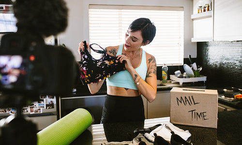 Woman video blogger reviewing sportswear